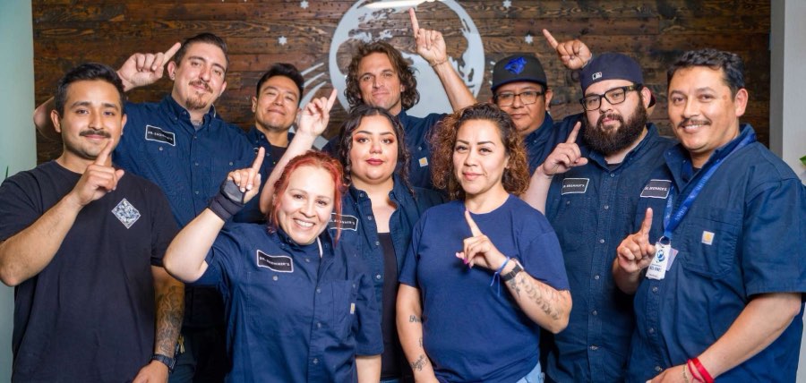 Dr. Bronner's Frontline Council team pointing up together